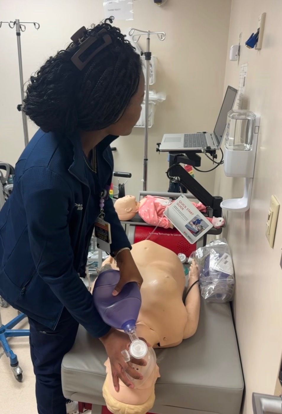 Onika Griffiths, RN, practicing bag-mask ventilation technique on a training mannequin